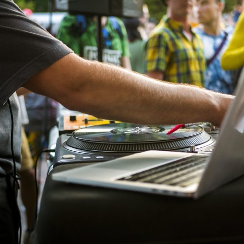 close up hand adjusting music settings on the laptop computer