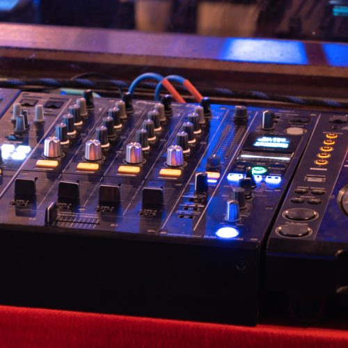 Mixes on CD players or track at nightclub during party for DJ. Nightlife of disco club in disco pub club bar background for party music dancing festival performance. Entertainment nightlife.